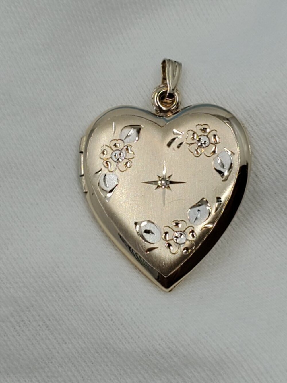 Women's 14k yellow and white gold stamped locket.